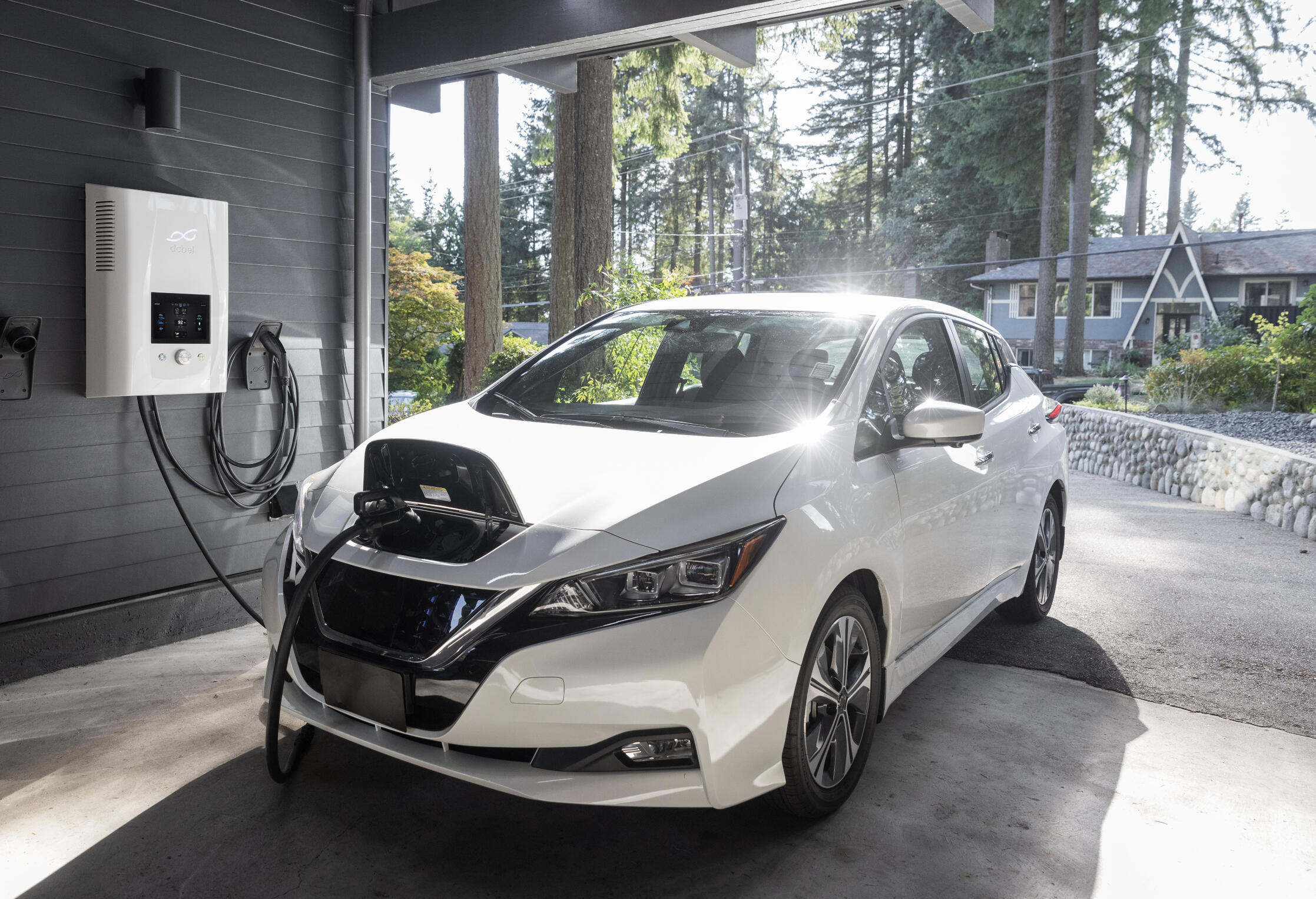 workmen install solar panels on a residential house